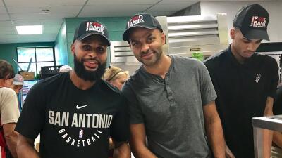 Patty Mills and Tony Parker help at the San Antonio Food Bank